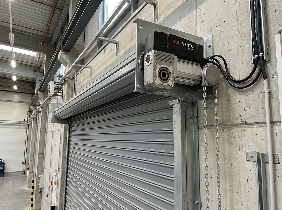 A Rollvento GK100 industrial door motor installed above a rolling shutter